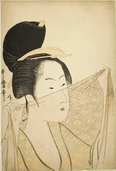 Woman Holding up a Piece of Fabric