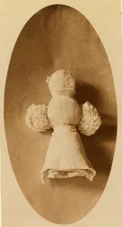 A Doll Made from Waste Material by a Child in a Knitting Mill Where Mother Works