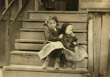 Portrait of Young Girl Taking Care of Baby Sister While Rest of Family is Working at Local Cannery, Bayou La Batre, Alabama, USA