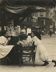 Three Young Girls Working at a Newspaper Stand on Canal Street in New York City