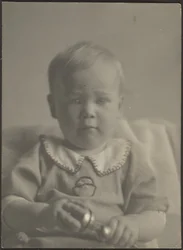 Baby Holding a Silver Rattle