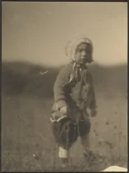 Child Wearing a Bonnet in Field