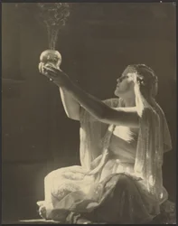 Costumed Woman Holding a Glass Incense Burner