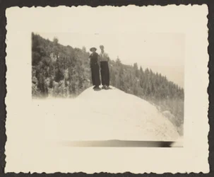 Figures Standing on Rock