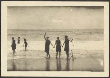 Figures on a Beach Holding Seaweed