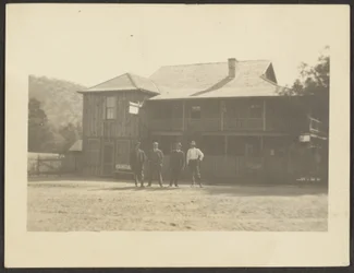 Four Men before Wooden Building