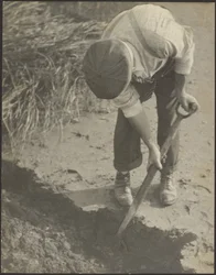 [Man Digging in Mud]