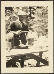 Man Standing at a Picnic Table