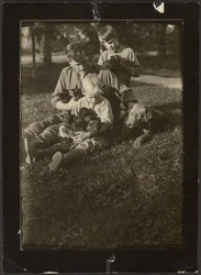 Man with Children and Puppies in Yard