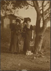 Portrait of Two Women Dressed Up in the Backyard