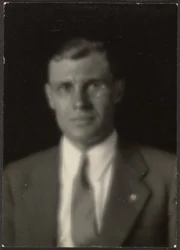 [Portrait of a Man with Glasses and Lapel Pin]