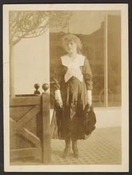 Woman Standing on Sidewalk