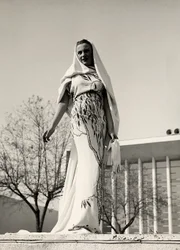 Model in an evening dress of floral print fabric, created by the couture house 