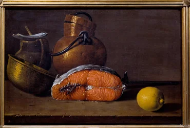 Slice of salmon, a lemon and utensils