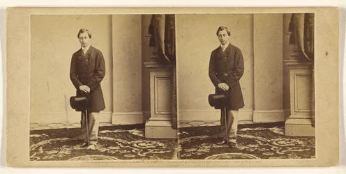 [Unidentified young man holding a top hat and walking stick, standing]