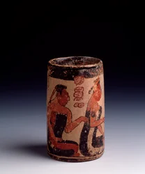 Pre-Columbian Art, Mayan Civilization, Classical Period: Cylindrical Clay Vase Decorated with Two Men and a Woman Performing a Ritual. From Tayasal, Guatemala
