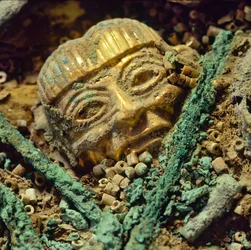 Gold head bead buried in the Moche royal tomb of the Old Lord of Sipan
