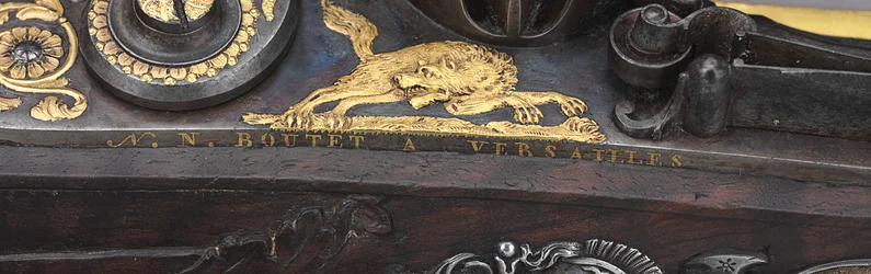 Detail of one of a pair of silver-mounted rifled flintlock pistols, Versailles