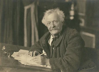 Félix Nadar seated at writing table