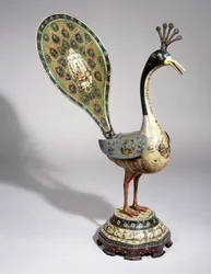 A Qajar peacock painted with flower designs, and pictorial cartouches depicting courtiers, 19th century