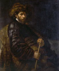 A seated man with a stick