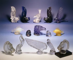 Various glass car mascots (of birds, fish, horses and a human head)