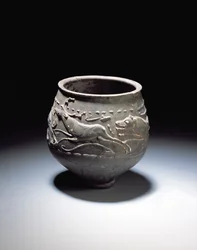 Beaker decorated with a hunt scene showing stag, hind and hounds, from the Roman site at Newstead, Melrose, AD 140-80