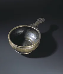 Bronze patera ornamented on the bulge, base and handle, from Whitehill, Westruther