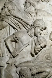 Roman warrior holding between his teeth the head of an enemy warrior