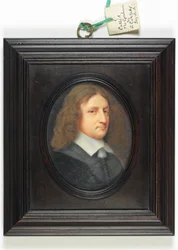 A gentleman in a dark grey coat, referred to as 