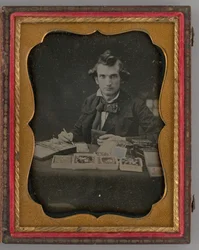 Untitled Portrait of Seated Man Holding a Daguerreotype and Brush