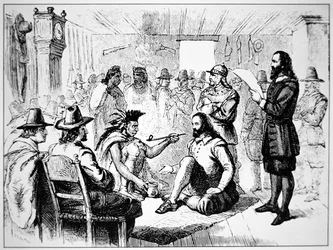 Massasoit, chief of the Wampanoag people, extends the peace pipe to John Carver in 1621