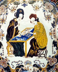 Two women playing checkers. China 18th century. ceramic. Milan
