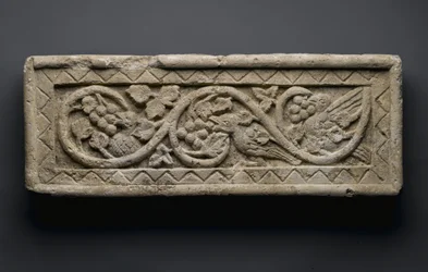 Relief of a plant scroll enclosing birds and grapes, from Behnesa, 5th-6th century
