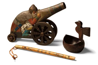 A toy limewood Bogatyr, a birchwood flute and a birchwood Kovsh, c.1900