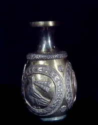 Sassanid crafts: gold silver carafe decorated with three medallions with embossed roosters