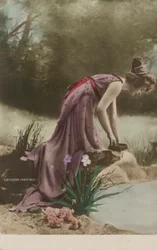 Woman looking into a pond