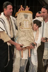 Bar Mitzvah boy carries Torah at Bar Mitzvah