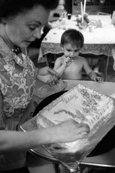 Mildred Cooper, a truck driver, decorates a birthday cake for one of her grandchildren