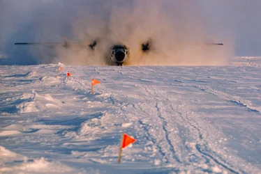 Obscured in smoke, supply plane lands on Arlis II