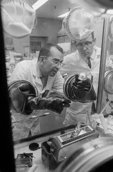 Technicians handle radioactive materials at Hanford operations of a plutonium recycling test reactor