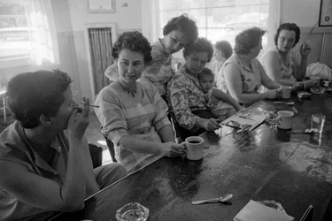 Women at a counter chat over breakfast in a diner in Oregon