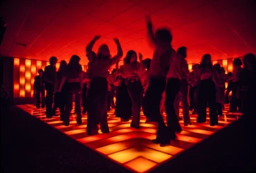 Young dancers at a nightclub dancing on an illuminated floor