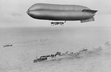RNAS Coastal Class Airship C23A Flying above a Warship Convoy, c.1917
