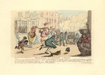 Man chasing his hat down a muddy street in a high wind