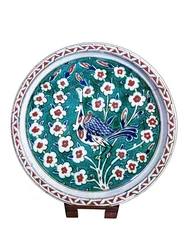 Peacock sitting on the branch of a wild rose bush, faience