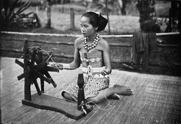 A Dayak Girl at Her Spinning Wheel