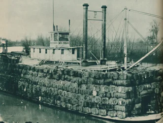 A Full Load of Cotton Often Mounts High Over the Decks of the Mississippi Steamboats