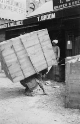 A porter lifting a large load, Chakrata, India