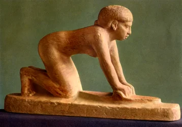 A woman grinding corn